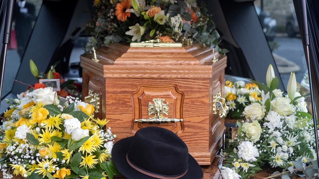 Liam Reilly’s signature hat lies beside his coffin in a hearse outside St  Joseph’s Redemptorist Church, Dundalk, Co Louth. Photograph: Colin Keegan/Collins Dublin