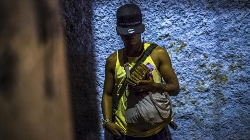 Militia target: a soldier in one of Rio de Janeiro’s drug gangs, which paramilitary groups have been trying to drive out. Photograph: Dado Galdieri/New York Times