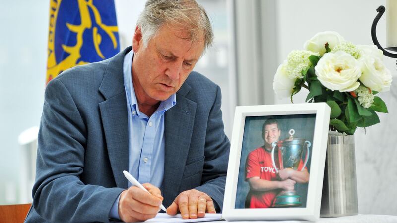 Former Cork and Limerick hurling manager Donal O’Grady signing the book of condolence in memory of the late Anthony Foley at Cork City Hall. Photograph: Daragh Mc Sweeney/Provision