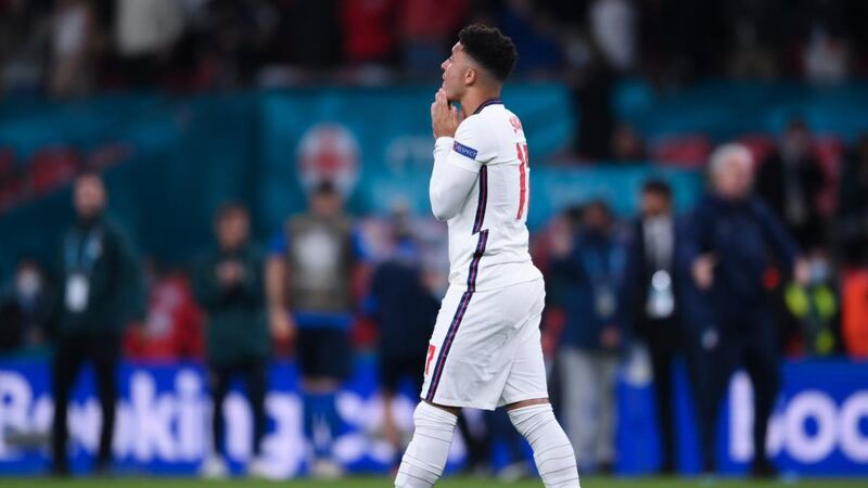Jadon Sancho reacts after missing a penalty against Italy. Photograph: Laurence Griffiths/Getty
