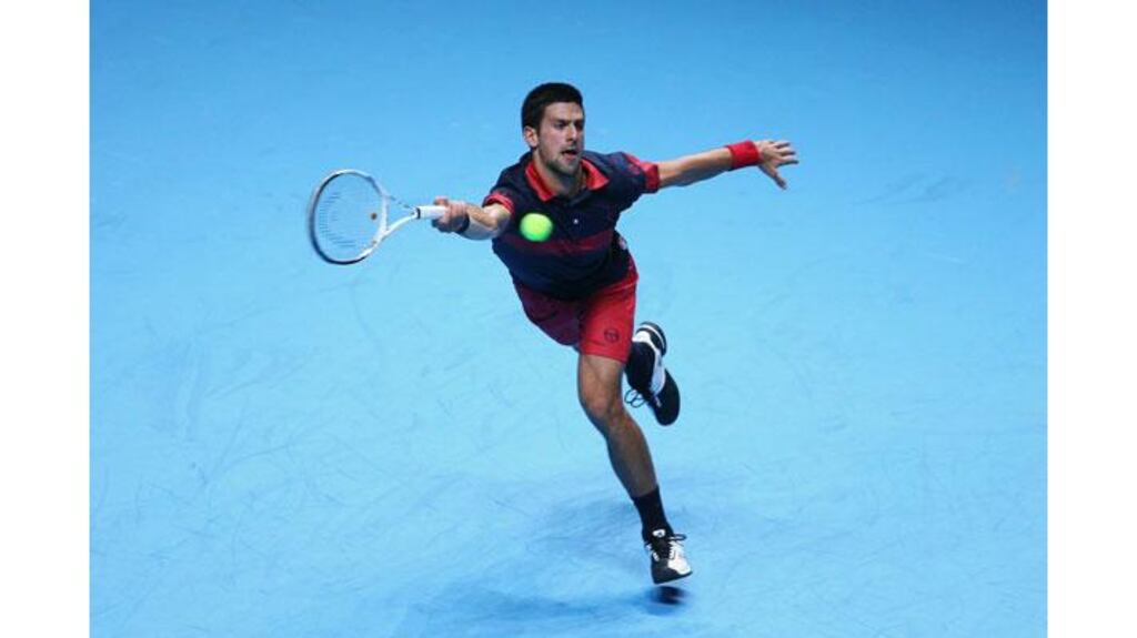Novak Djokovic stretches to reach a Tomas Berdych serve during their match in the ATP World Tour Finals today. Photograph: Julian Finney/Getty Images