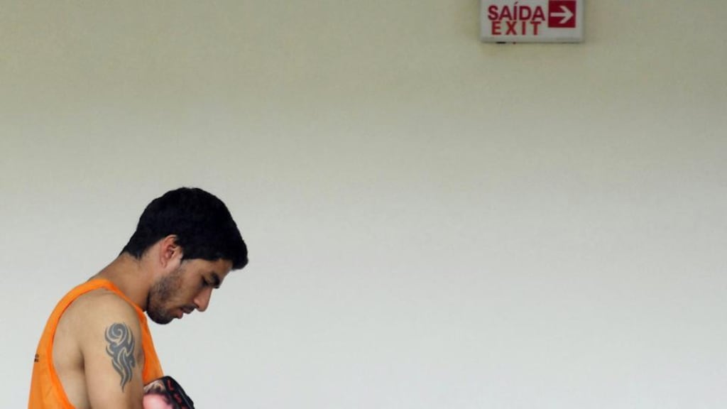 Uruguayan Luis Suarez leaves the team training centre in Natal after being given a four-month ban from football as well as a nine-match international ban by Fifa. Photograph: Ney Douglas / EPA