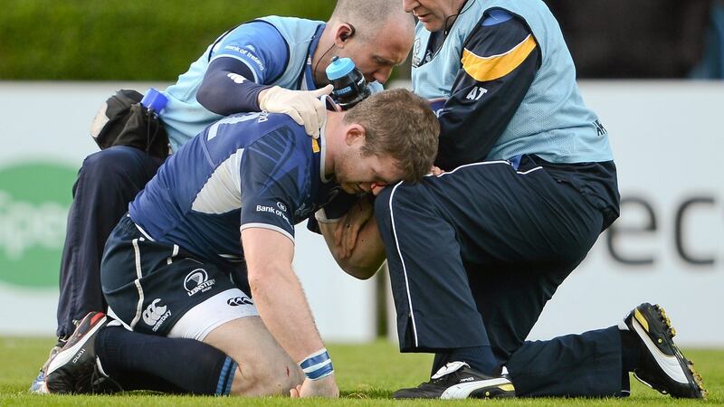 ‘The only evidence of my rugby career on the wall of our home’ – Leinster’s Gordon D’Arcy is attended to by team physio Garreth Farrell and team doctor Prof. Arthur Tanner after receiving a blow to the head from a team-mate’s knee. Photo: Brendan Moran/Sportsfile