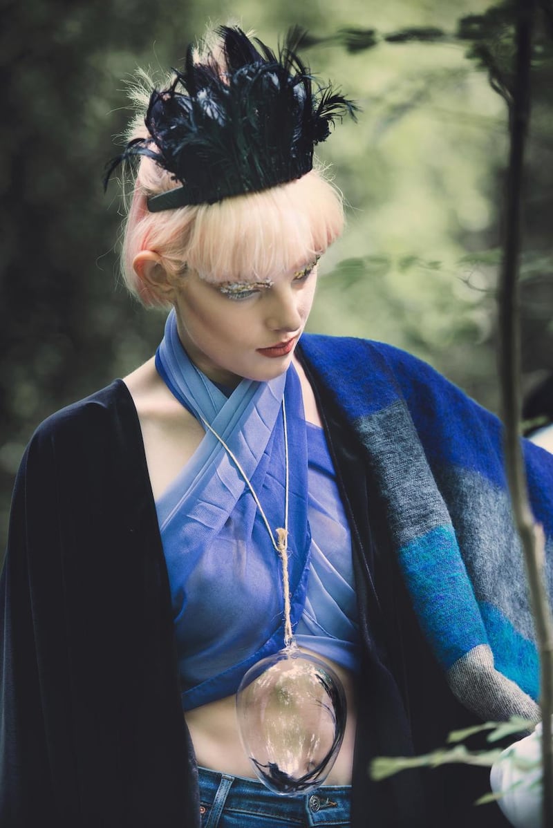 Blue scarf €9 used as top, oversized wool scarf €15 both from Casa Crafts Cork. Vintage black velvet cape €100 from The Retro Workshop Cork. Jeans €68 from Topshop. Glass keepsake pendant €35 and feather headband €50 both by Mary Ginnifer Designs