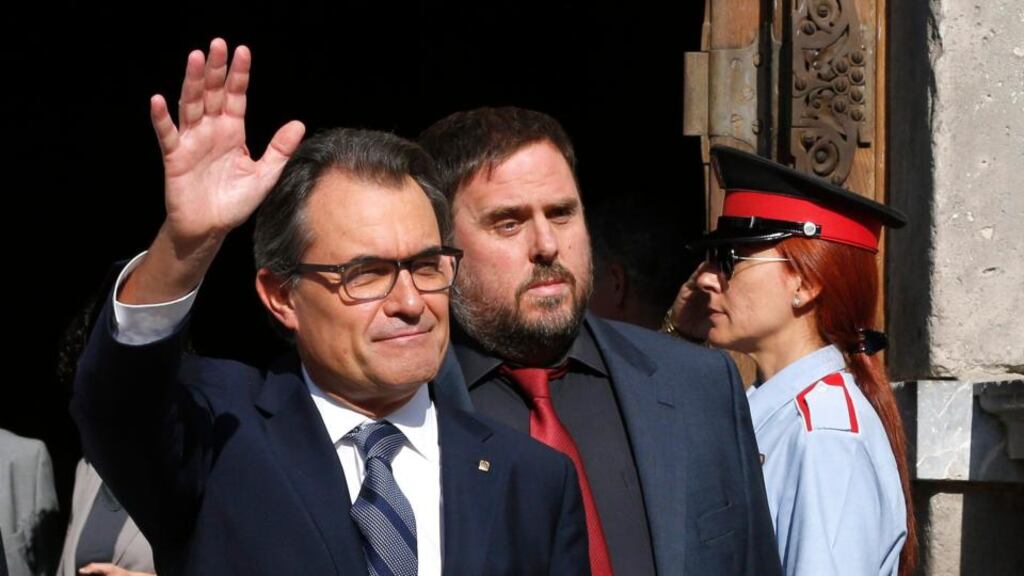 Catalonia’s president Artur Mas (left) waves to pro-independence supporters near Catalonia’s Republican Left leader Oriol Junqueras, as they leave the Palau de la Generalitat (Government Palace) after signing a decree calling for an independence referendum. Photograph: EPA