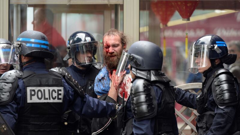 Police officers detain an injured demonstrator during a protest against the French government’s planned labour law reforms in Paris. Photograph: Alain Jocard/AFP/Getty Images