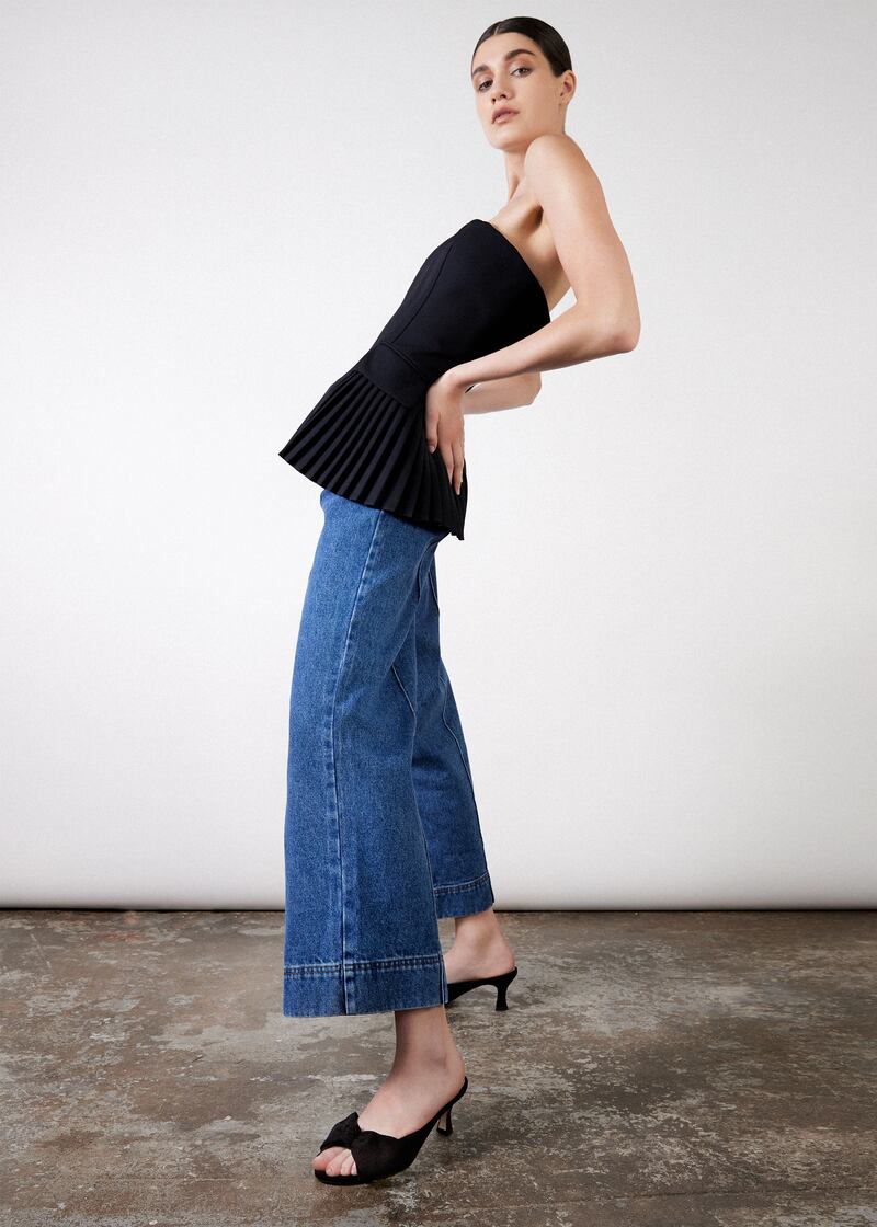 Strapless black top €519 Simkhai, Gallery 9, blue cropped flared jeans €215 with black suede bow kitten heel costing €230 from Nicki Hoyne