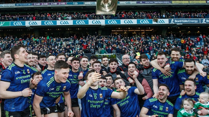Mayo’s Fergal Boland celebrates by throwing the trophy in to the air after they beat Kerry to win the Allianz Football League Division One title. Photo: James Crombie/Inpho