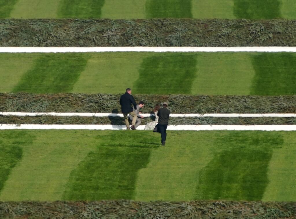 Activists attempting to attach themselves to a fence ahead of the Randox Grand National at Aintree Racecourse, Liverpool. Photograph: Peter Byrne/PA Wire.