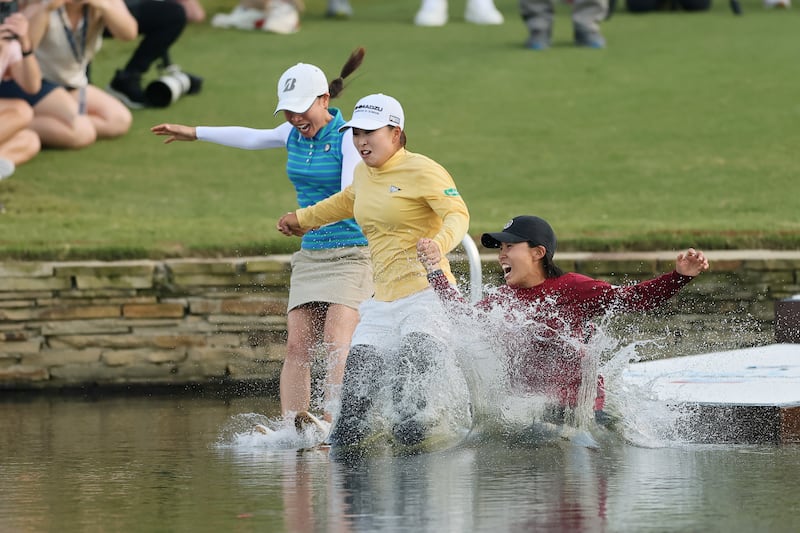 Mao Saigo, centre, jumps in the pond on the 18th hole with members of her team after winning The Chevron Championship at Carlton Woods on Sunday. Photograph: Alex Slitz/Getty Images