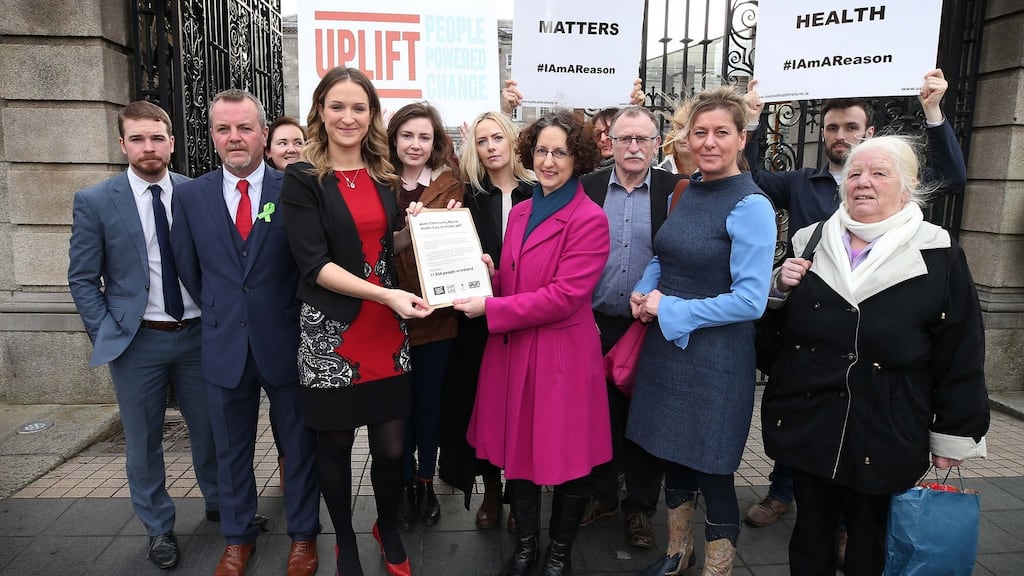 Minister of State for Mental Health and Older People Helen McEntee TD receives a petition of almost 12,00 signatures from Shari McDaid , calling for the delivery of 24/7 crisis mental health services across Ireland. Photograph: Conor McCabe Photography