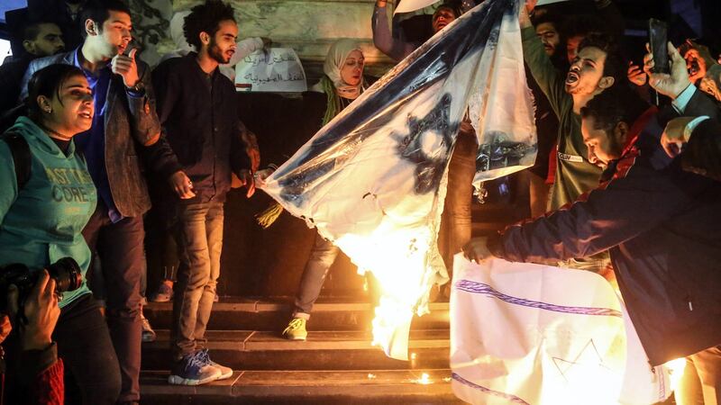 Protesters shouts slogans against US president Donald Trump and burn Israeli flag during a protest against the Israel in Cairo. Photograph: Mohamed Elraai/ EPA