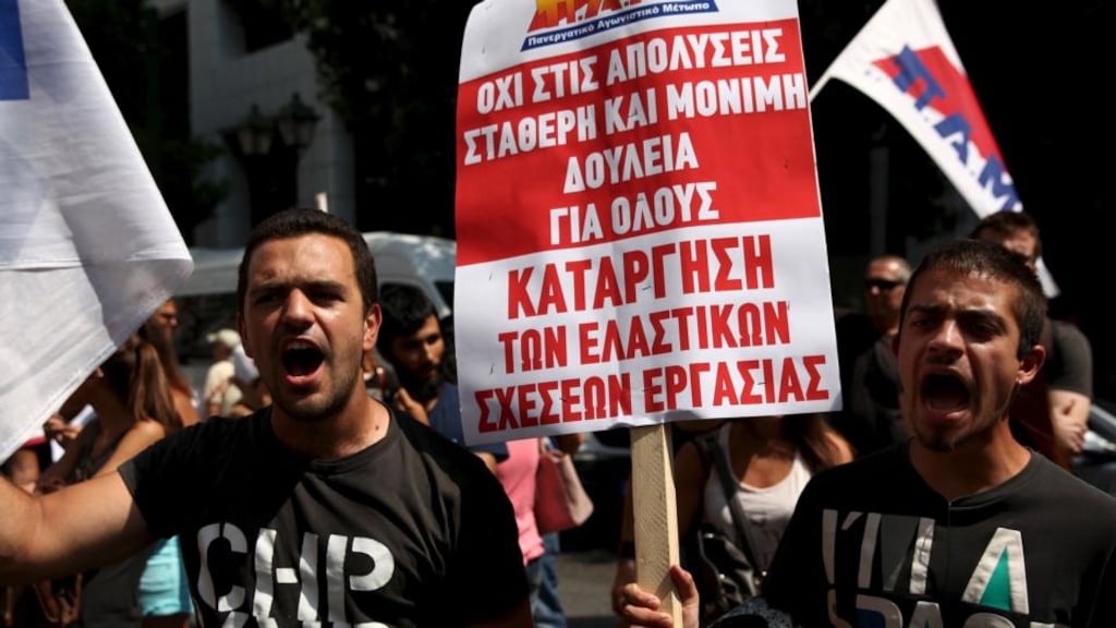Protesters from the Communist-affiliated trade union PAME at an anti-austerity demonstration in Athens on Wednesday. The parliamentary spokesman for the Syriza party urged it to unite behind a new funding agreement, saying the country wanted a full bailout immediately rather than a bridge loan. The placard reads, “No to layoffs. Steady and permanent jobs for everybody”. Photograph: REUTERS/Yiannis Kourtoglou