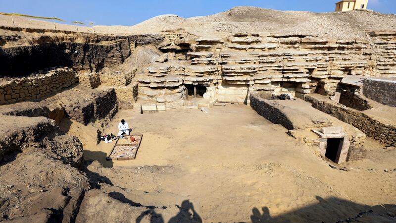 An archaeologist works outside a newly discovered tomb, at the Saqqara area in Egypt. Photograph: Mohamed Abd El Ghany/Reuters