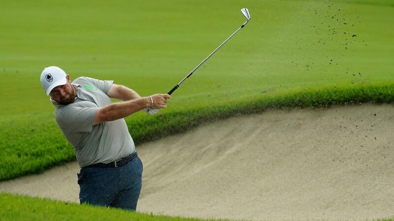 Shane Lowry plays a shot from a bunker on the 11th hole. Photo: Matt York/AP Photo