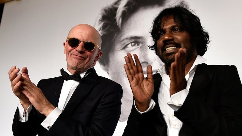 Jacques Audiard and Dheepan star Jesuthasan Antonythasan after winning the Palme d’Or on May 24, 2015. Photograph: Pool/Getty Images