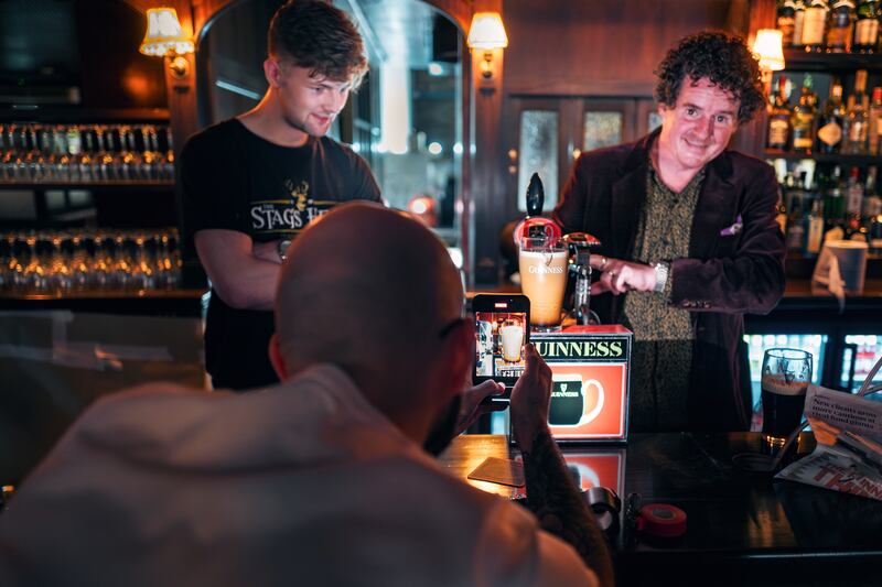 Sam Donohoe, left, and Oisín Rogers pulling a pint of Guinness. Photograph: Mike Taylor