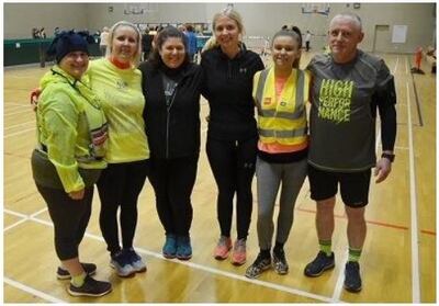 Ready for a Parkrun. Julie is third from the right.