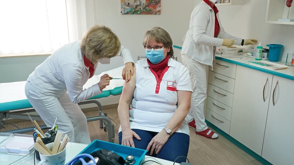 A doctor vaccinating a healthcare worker at her private practice in the state of Brandenburg, Germany. Photograph: EPA/Sean Gallup