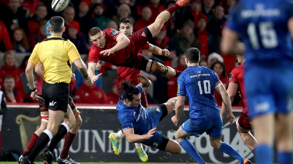 Leinster’s James Lowe collides with Munster’s Andrew Conway during the Guinness Pro 14 derby at Thomond Park. Photograph: Dan Sheridan/Inpho