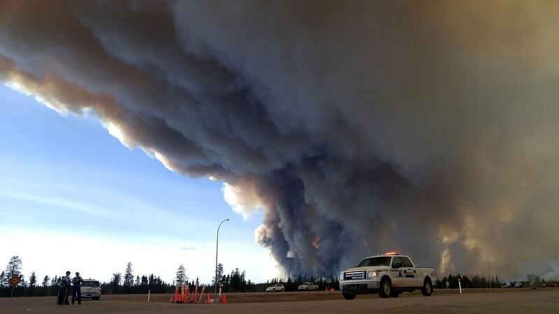 Members of the Royal Canadian Mounted Police monitor the Fort McMurray Wildfire. Photograph: RCMP Alberta/AFP/Getty Images