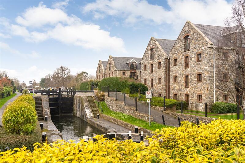 Situated on the first floor, the unit has a balcony overlooking communal gardens