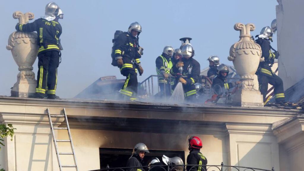 Firemen try to extinguish a fire at the 17th century Hotel Lambert in the Ile Saint Louis in Paris today. Photograph: Reuters