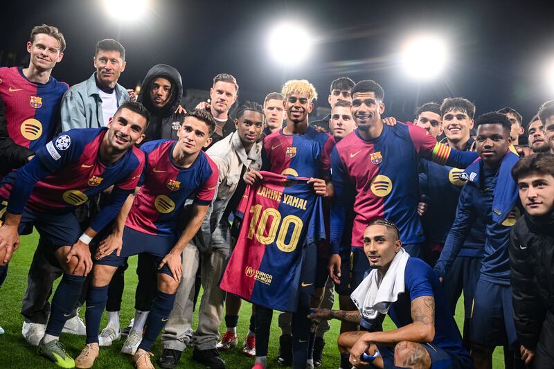 Lamine Yamal with the team after being awarded a match shirt celebrating his 100th appearance for Barcelona after the Champions League match against Inter Milan. Photograph: Michael Regan/Uefa via Getty Images