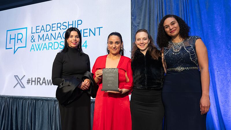 Maureen Walsh, managing director, Decare Dental, presents the best health and wellbeing strategy award to the Fragomen team