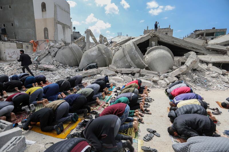 Palestinians pray on the ruins of Al-Farouq Mosque, which was destroyed by Israeli air strikes in Rafah, Gaza. Photograph: Ahmad Hasaballah/Getty Images