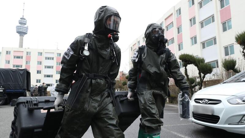 South Korean soldiers from the Armed Force CBR Defense Command wearing protective gear enter a building for disinfection work at a closed apartment complex after 46 residents were confirmed to have the COVID-19 coronavirus, in Daegu, South Korea. Photograph: Yonhap / AFP / South Korea OUT via Getty Images