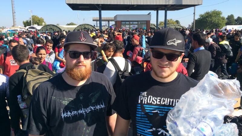 Ilias and Basti handing out water as part of a group of about 20 volunteers from Regensburg, Germany. Photograph: Daniel McLaughlin