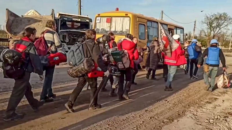 Russian servicemen and Red Cross volunteers escorting civilians who were evacuated from Azovstal, in Mariupol, to buses. Photograph: EPA/Russian Defence Ministry