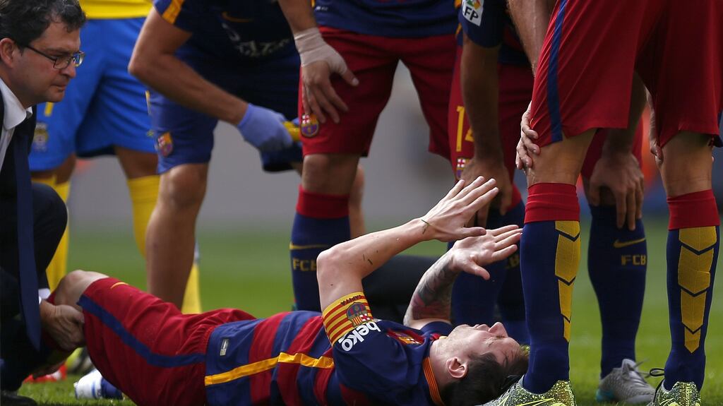 FC Barcelona’s Lionel Messi reacts after being injured during a Spanish La Liga match against Las Palmas at the Camp Nou stadium in Barcelona Photograph: Manu Fernandez/AP Photo