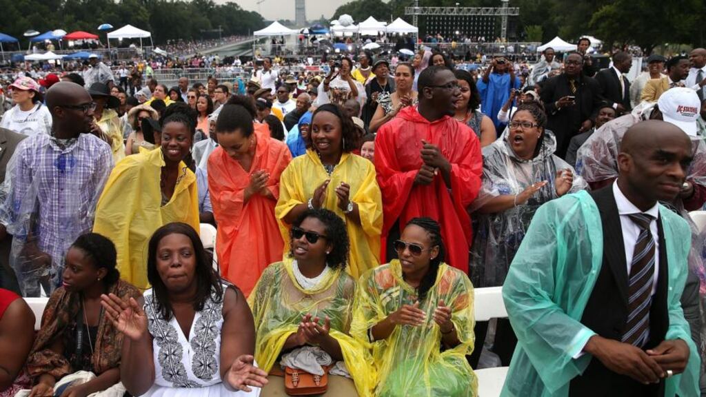 People sing along to gospel music during a ceremony to commemorate the 50th anniversary of the March on Washington for Jobs and Freedom