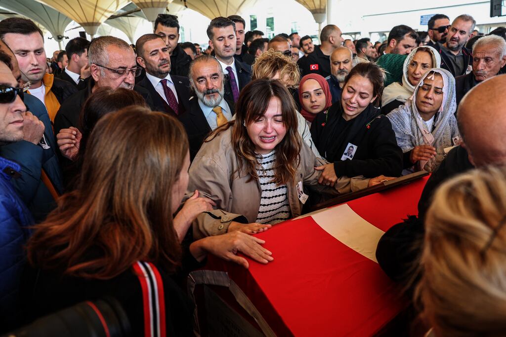 Family members and relatives mourn next to the coffins of three people who were among five killed in a bomb attack on a TAI campus in Ankara. Photograph: Adem Altan/AFP via Getty Images