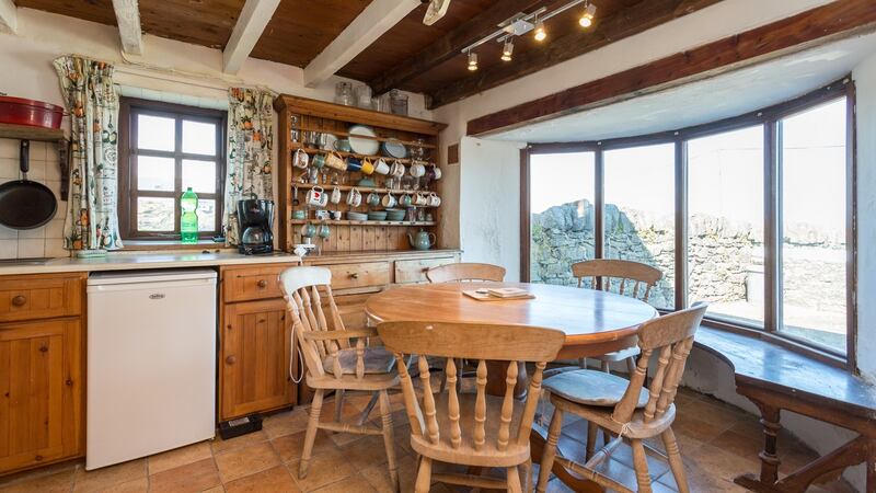 Decent sized eat-in kitchen with its round table filling the curve of its bow window.