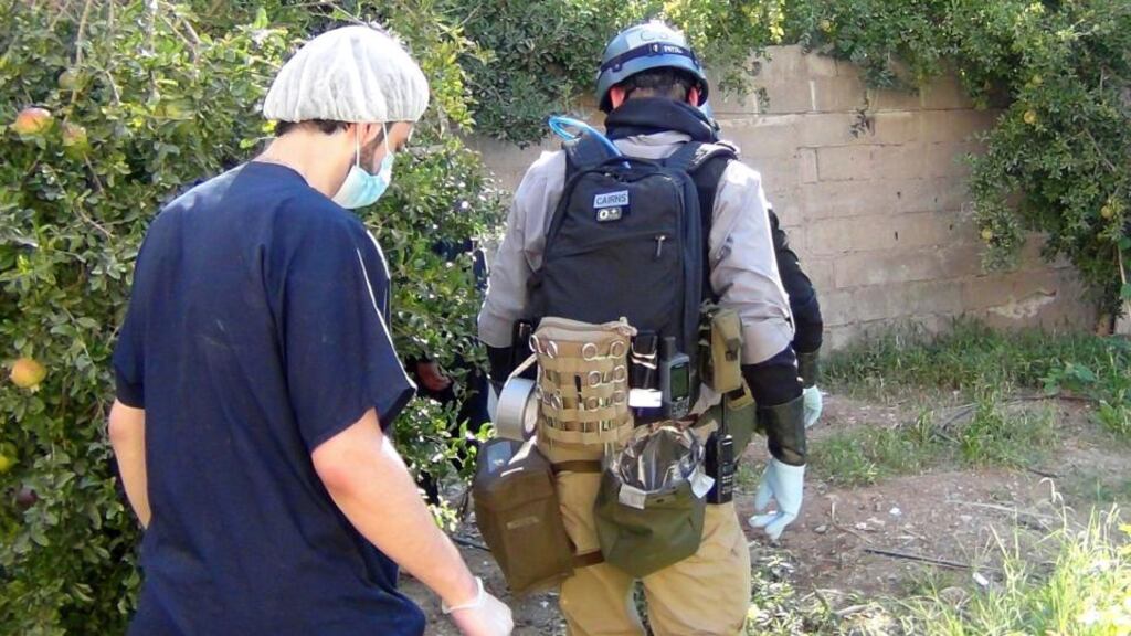 A UN chemical weapons expert (right) gathers evidence at one of the sites of an alleged poison gas attack in the southwestern Damascus suburb of Mouadamiya yesterday.  Photograph: Ahmad Alshami/Reuters
