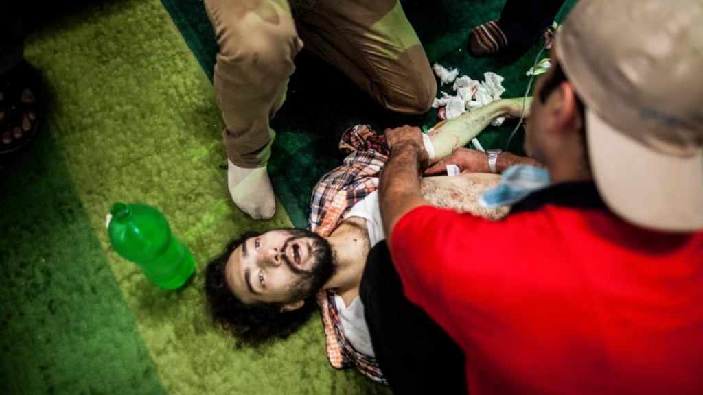 Medical personnel help a pro-Morsi demonstrator at Al-Nour mosque on Ramses Square. Photograph: Bryan Denton/The New York Times