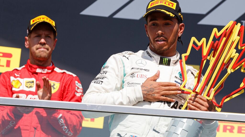 Formula One drivers Lewis Hamilton of Mercedes AMG GP and Sebastian Vettel of Scuderia Ferrari react on the podium after the 2019 Canada Formula One Grand Prix in Montreal, Canada. Photograph: Valdrin Xhemaj/EPA