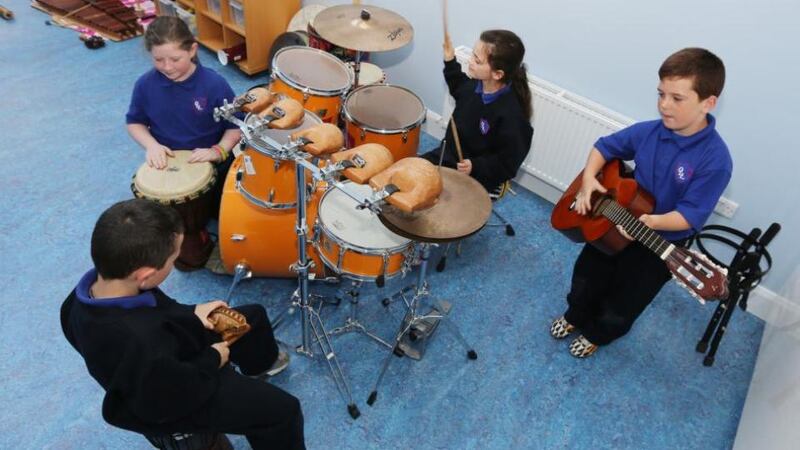Volunteers from Our Lady of Lourdes National School, Patrick Nolan (8) on guiro, Ciaran Bannon (8) on djembe, Zoe Malone (8) on drums and Lee Nolan (8) on guitar, attend the Blue Box creative therapies. Photograph: Liam Burke/Press 22