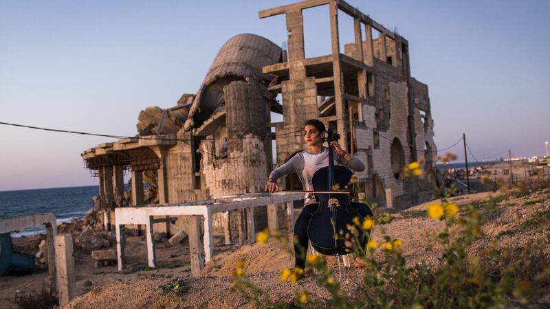 A musician playing amid the ruins in Gaze