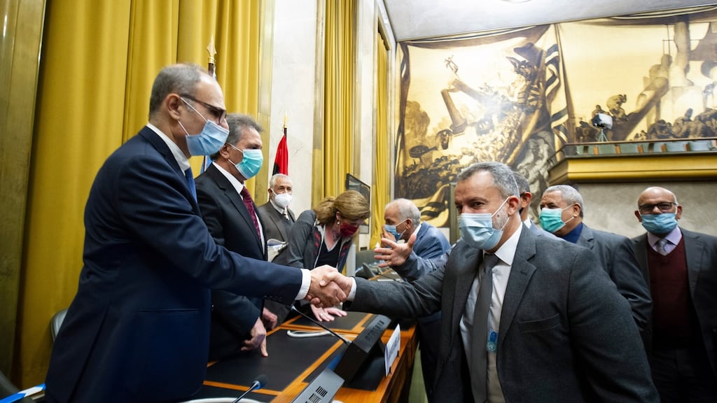 Participants shake hands after signing an agreement for a permanent ceasefire in Libya, at a UN building in Geneva, Switzerland. Photograph: Violaine Martin/EPA