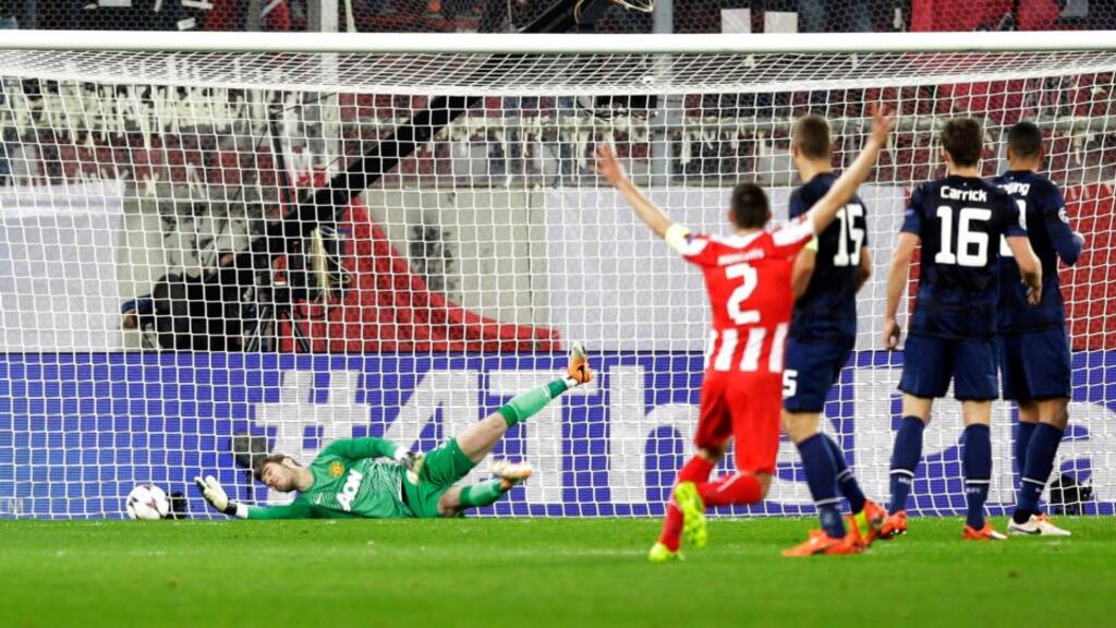 Alejandro Dominguez’s flick beats the Manchester United goalkeeper David de Gea for Olympiakos’ first goal. Photograph: Thanassis Stavrakis/AP