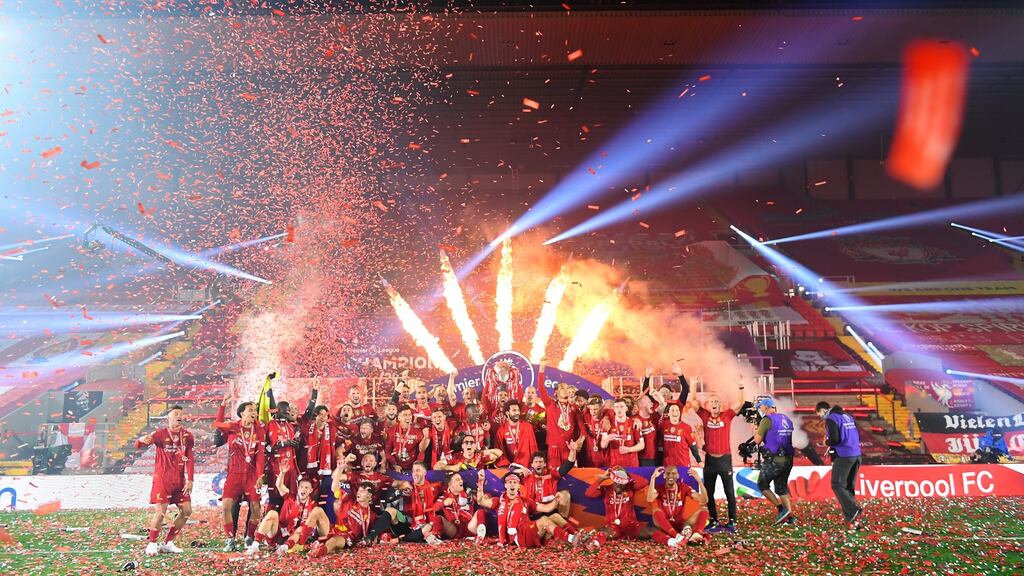 Jordan Henderson of Liverpool holds the Premier League trophy aloft at the end of last season. Photo: Laurence Griffiths/Getty Images
