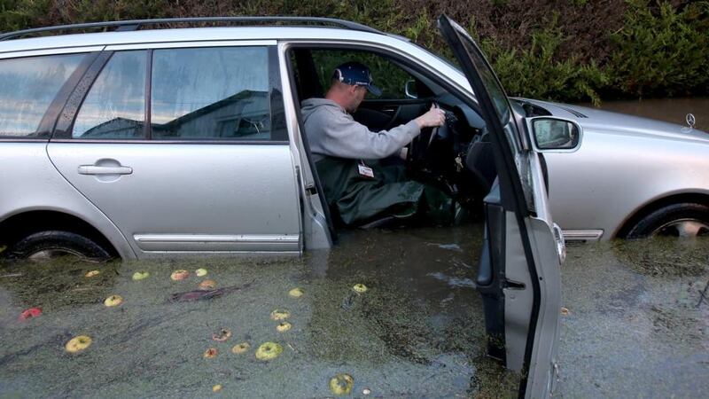 People watch waves breaking against the rocks near North beach or Praia do Norte in Nazare, Portugal. The waves at Praia do Norte are famed for being amongst the biggest in the world and it is a popular spot for daredevil big-wave surfers. Photograph: Pablo Blazquez Dominguez/Getty Images