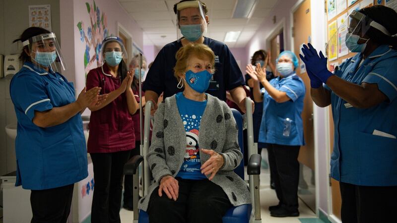 Margaret Keenan is applauded by staff as she returns to her ward after receiving the Pfizer/BioNtech vaccine at University Hospital, Coventry. Photograph: PA Wire