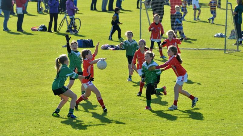 Members of the Lucan Sarsfield and Clontarf teams battle for the ball. Photograph: Alan Betson