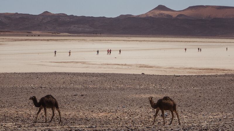 Participants cross a dry lakebed on the final day.