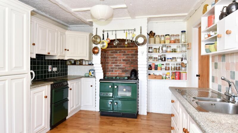 The kitchen/diningroom has a green Stanley range in a brick-lined alcove.